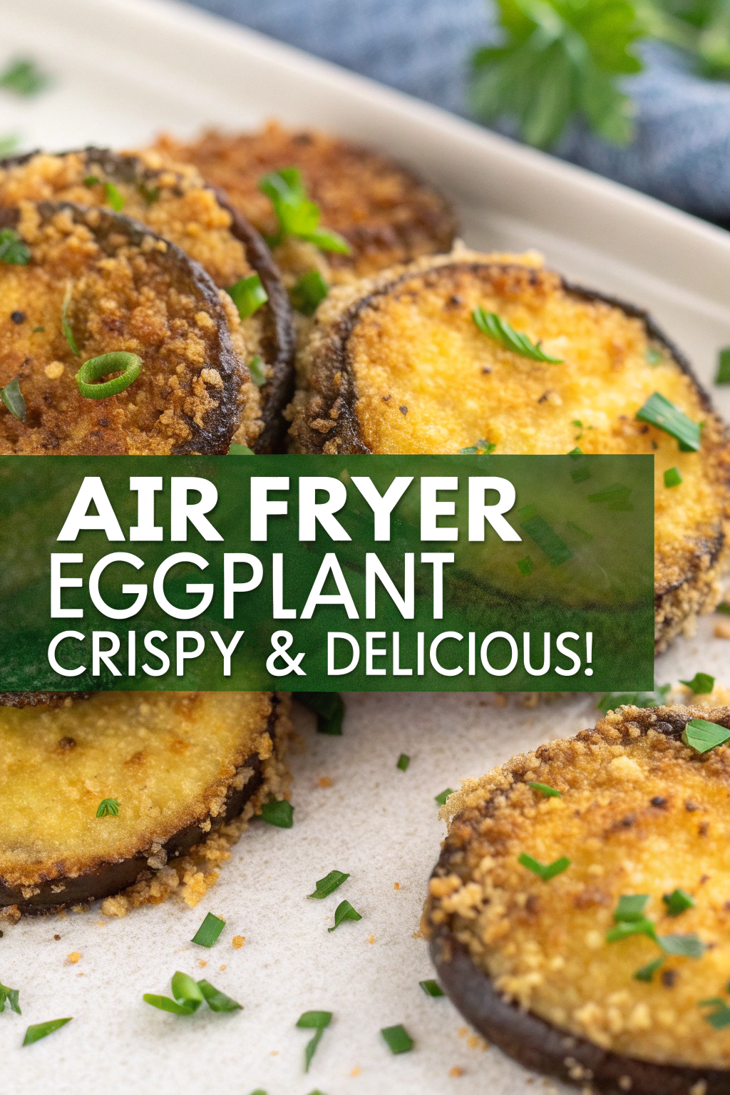 A golden-brown, crispy air fryer eggplant, sliced and served on a plate, with a light, golden crust and tender inside. The texture contrasts between crispy edges and soft interior is highlighted in the photo.